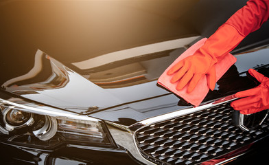 Car wash cleaning concepts . Auto service staff cleaning car with microfiber cloth in Interior car console