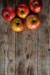 Ripe and juicy apples lie on a wooden table
