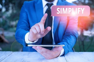 Writing note showing Simplify. Business concept for make something simpler or easier to do or...