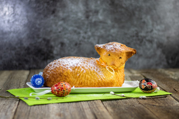 Golden Easter lamb cake with Easter egg on old wooden table