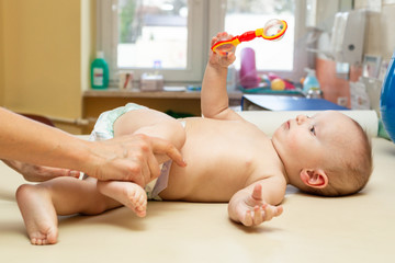 Pediatric Physical Therapy - an infant exercising on a table