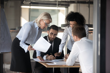 Multi-ethnic businesspeople financiers analyzing financial statistics work results