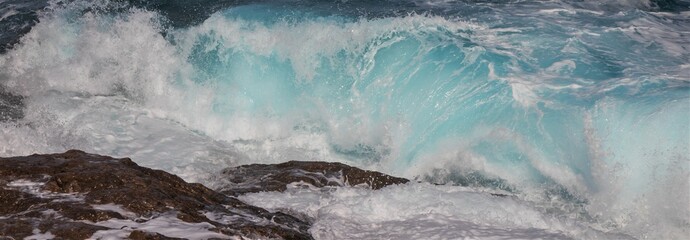 crashing wave with white spray and turquoise blue water, banner