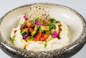 Stracciatella di bufala with avocado and fresh tomatoes