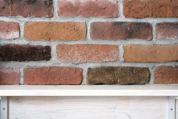 White wooden shelf with space of vintage brick wall background