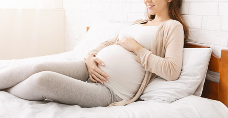 Calm pregnant woman touching her belly, panorama - obrazy, fototapety, plakaty