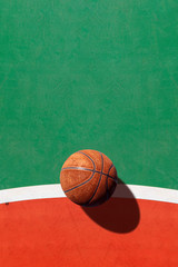 sport concept. old basketball on court. over light