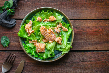 fish salad canned salmon (lettuce and other ingredients) menu concept background. top view. copy space