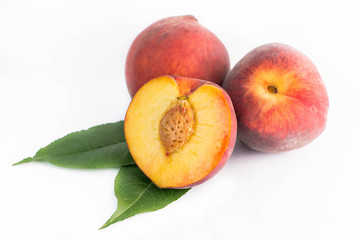 peaches with leaves isolated on white