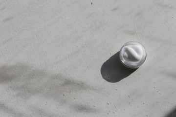 Fototapeta na wymiar cosmetic cream bottle on grey background, white cream