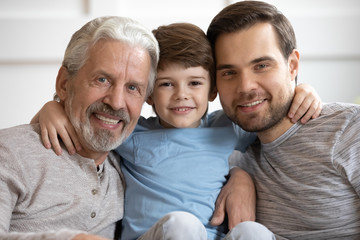 Portrait of happy three different generations bonding male family.