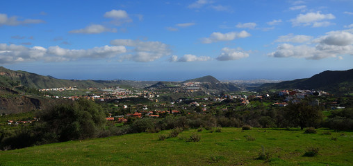 Fototapeta na wymiar Beautiful landscape, green prairie and blue sky with scattered clouds, Valsequillo village, Gran Canaria, Canary Islands