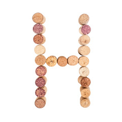 The letter "H" is made of wine corks. Isolated on white background