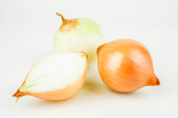 Fresh onion bulbs and onion slices isolated on white background