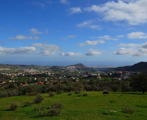 Fototapeta na wymiar Beautiful countryside landscape, green prairie and splendid blue sky with clouds, Valsequillo de Gran Canaria, Spain