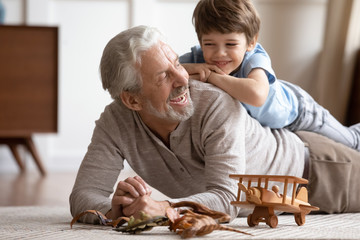 Joyful different generations family playing together at home.