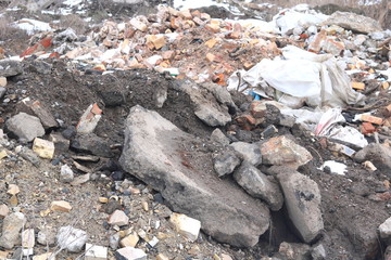 Construction waste with elements of various dismantled and destroyed old structures at municipal landfill