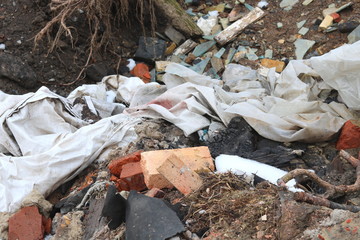 Construction waste with elements of various dismantled and destroyed old structures at municipal landfill
