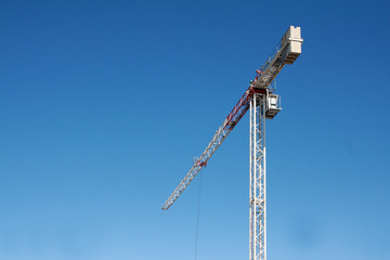 Tower construction crane on a background of blue sky