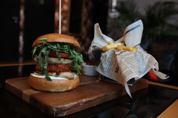 burger and fries on wooden tray