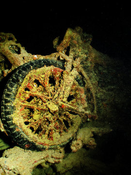 Submerged BSA and Matchless motorbikes loaded on trucks inside the cargo hold of the sunken SS Thistlegorm wreck.