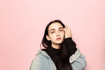 Portrait of happy middle-eastern female posing against a pink background. Studio portrait of a stylish young woman. Beauty, fashion, seasonal vogue style weeks concept