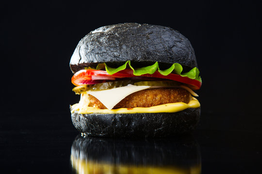 Delicious Fast Food. Modern Black Burger On Black Bacground. Toned Picture