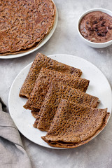 Sweet breakfast or dessert: chocolate crepes (thin pancakes) and chocolate cream.