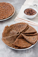 Sweet breakfast or dessert: chocolate crepes (thin pancakes) and chocolate cream.