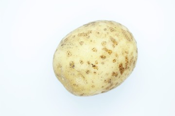 Unpeeled potatoes perched on a white background