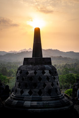 sunset above stupa at Borobudur temple in indonesia - obrazy, fototapety, plakaty