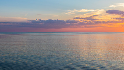 Fototapeta premium Beautiful, colorful sunset on the shore of the Baltic Sea on a warm summer evening. Colorful skies and clouds