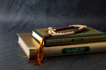 Quran - holy book of Muslims religion, Concept: open book holy prayers for god,  Friday In the month of Ramadan  religion Islamic worshiping faith and learn koran and rosary put on wooden  boards 