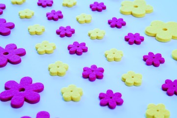 Decorative pattern with yellow and pink felt flowers. seamless artificial floral background
