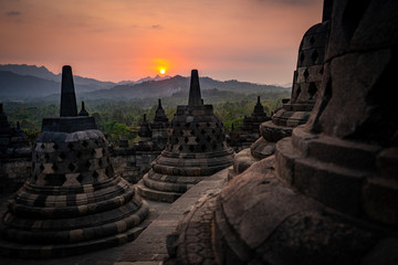 sunset at Borobudur temple in indonesia - obrazy, fototapety, plakaty