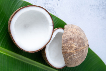 coconuts and Coconut oil product organic for cosmetic natural care health in a bottle put on a white table,  Concept: alternative aromatherapy aromatic ingredient vitamin for therapy and massage spa