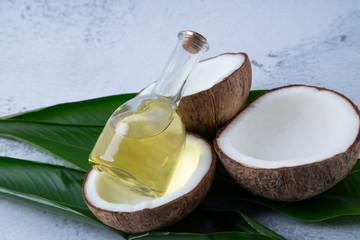 coconuts and Coconut oil product organic for cosmetic natural care health in a bottle put on a white table,