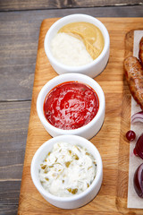 different sauces on the wooden tray