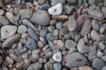 sea pebbles colored granite on the beach background stones.