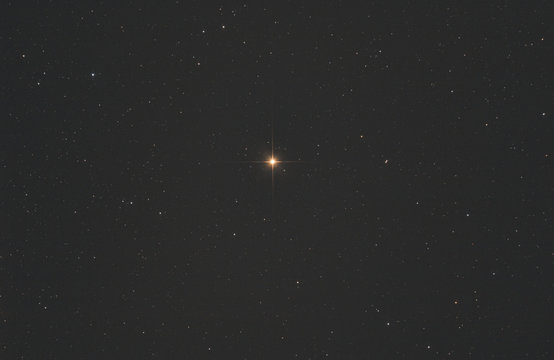 Closeup of Betelgeuse star or alpha Orionis in Orion constellation, with many stars as background in the deep space.