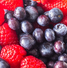 Sweet berries of raspberry and blueberry close up