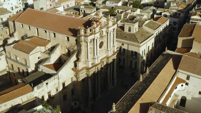 Cinematic flying on an early sunny morning over an old Baroque Church in the historic part of Palermo. Aerial shoot