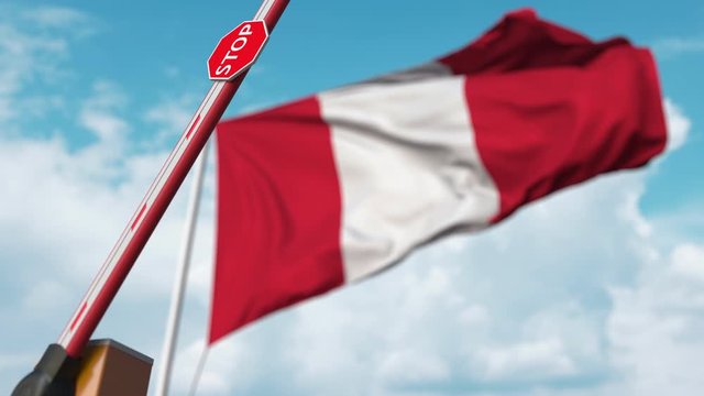 Opening boom barrier with stop sign against the Peruvian flag. Free entry or lifting a ban in Peru