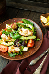 Grilled chicken salad with lettuce, capsicum, avocado and tomatoes. Vertical image