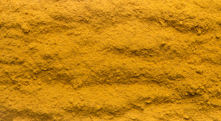 Turmeric powder texture background, copy space for text,