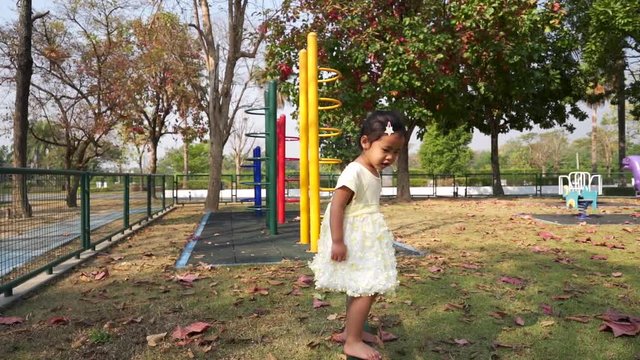 Little girl playing at playground on sunny day, slow motions