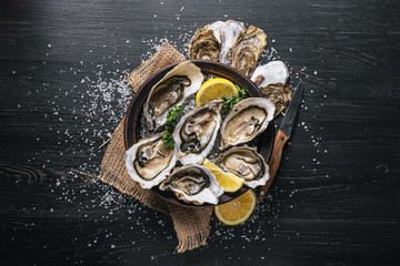 Fresh oysters with lemon ice and white wine. © Mykhailovskyi