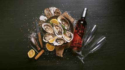 Fresh oysters with lemon ice and white wine. © Mykhailovskyi