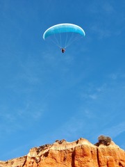 Man is paragliding in Albufeira in Portugal at the beach