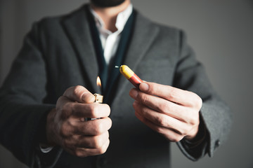 man hand lighting up a firecrackers  on dark background